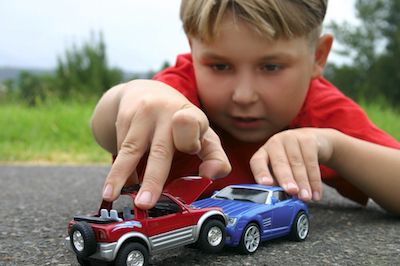 Boy playing with toy cars